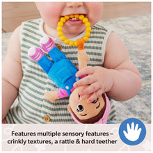Baby teething on plush take-along toy, yellow bead ring and colorful straps