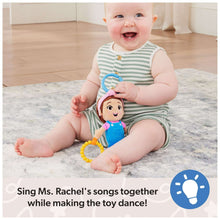 Baby sitting with sensory take-along plush, blue handle loop, rattle and teether