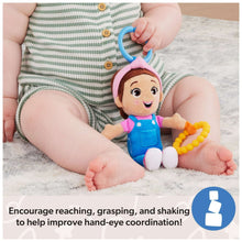 Sensory take-along plush with rattle and bead teether, held by a baby on a rug