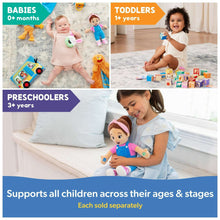 Child playing with sensory take-along plush toy with rattle and teether on the floor