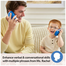 Kid holding a blue learning phone to their ear while a parent speaks during play