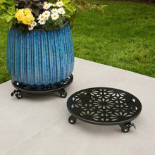 Black round plant caddy with geometric cutouts and caster wheels; blue planter shown
