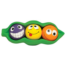 Green latex pea pod dog toy with three squeaker balls: purple, yellow, and orange faces
