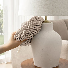 Gray noodle hand towel with pom-pom loop texture and hanging tie on the handle