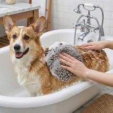Gray noodle hand towel in a bathtub, being held while bathing a dog