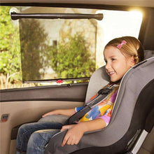 Black mesh car window baby roller shade attached inside a car with child
