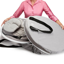 Gray baby swing travel case open with padded insert and black strap handles