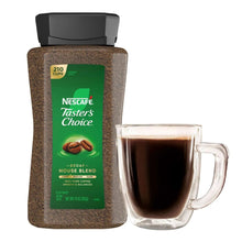 Decaf instant coffee canister with green label and glass mug of brewed coffee