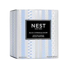 Blue-and-white striped NEST scented candle box, front label and chevron pattern