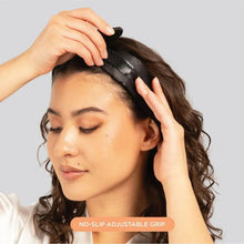 Black satin headband with adjustable strap, held in place at hairline