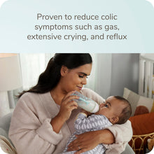 NUK Smooth Flow Pro anti-colic baby bottle held during feeding by a parent