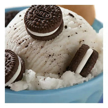 Ice-cream cup with chocolate sandwich cookie, crumbs, and a wafer cookie piece on top