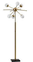 Tall brass floor lamp with central medallion and six white globe lights