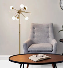 Brass floor lamp with starburst arms and white globe shades
