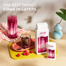 Berry Blossom Tea body wash pouch and bottle set on a tabletop with berries