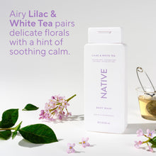 Native body wash bottle, Lilac & White Tea, with small purple flowers nearby