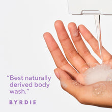 Hand with foam lather under a shower stream