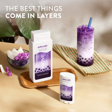 Body wash bottles with scent labels and a purple boba drink on a tray