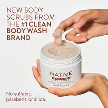 Coconut & Vanilla body scrub jar held in hands with creamy scrub inside