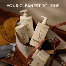 Native shampoo bottles with pumps arranged in a brown leather carrying bag