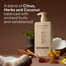 Native sandalwood & coconut shampoo bottle with pump on countertop, surrounded by fruit and herbs