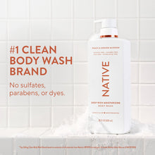 Moisturizing body wash bottle with orange pump, white label with orange and peach details.