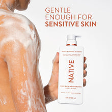 Native body wash bottle held beside wet, foamy skin on a person’s torso.