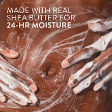 Foamy body wash on hands and wrists with thick white bubbles.