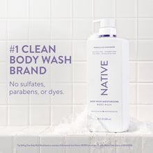 Vanilla & Cashmere body wash bottle with purple pump on countertop, 22 fl oz.