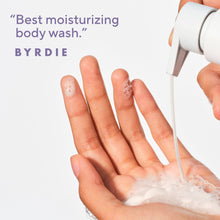 Body wash foam lathering on open hands with white nozzle dispensing.