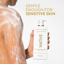 Moisturizing body wash bottle with pump, held near soapy, wet skin