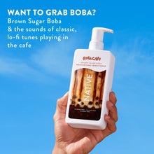 Hand holding Brown Sugar Boba moisturizing conditioner bottle with white pump, Boba Cafe