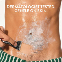 Shaving cream lather on skin as a razor glides across