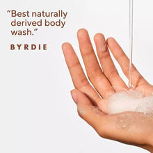 Nourishing body wash foam in palm, hands covered in suds