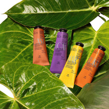 Hand cream set with four squeeze tubes in orange, purple, and yellow