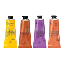 Hand cream set of four hand creams in tubes with black caps: yellow, orange, purple