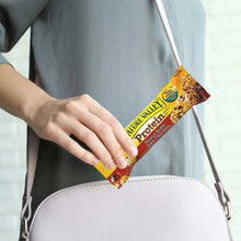 Nature Valley protein chewy bar in hand with wrapper, peanut butter dark chocolate