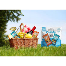 Probiotic multi-pack snack bags near fruit and beverages in a picnic basket