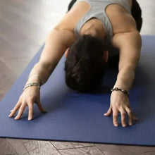 Blue yoga mat with textured grip surface