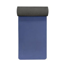Blue yoga mat standing vertically with rolled top end.