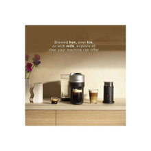 Coffee maker on kitchen counter with cups and milk frother container