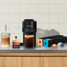 Liquorice Black Nespresso Vertuo Pop+ machine on counter with cups and pods