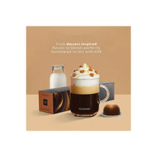 Dessert-style coffee drink with foam layers and capsule pod beside it