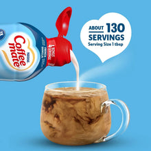 Coffee creamer bottle pouring into an iced coffee mug