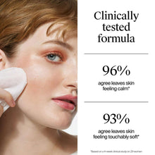 Makeup remover wipe in use on face, white cleansing cloth held to cheek