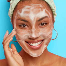 Acne face wash foam on face and hands, covering skin with white lather
