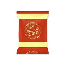 Single ground coffee packet, red with yellow stripes and New England Coffee logo