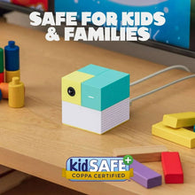 Kids-safe smart cube device with colored blocks on wooden tabletop