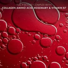 Red liquid with many bubbles and droplets surrounding a small metal loop