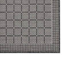 Area rug with dense gray lattice grid pattern and subtle border on edge